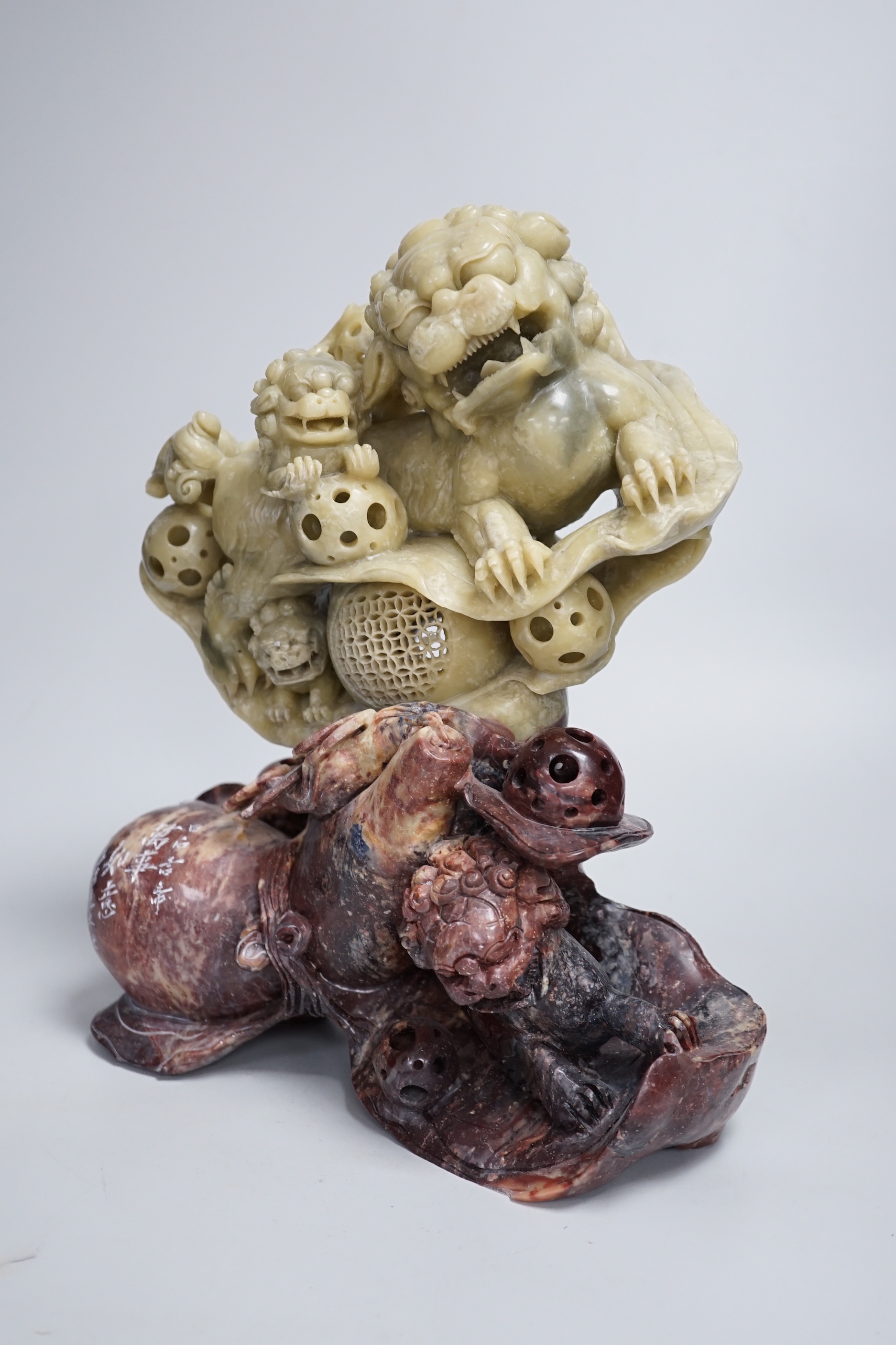A Chinese soapstone sculpture of a lion dog group, 31.5cm high